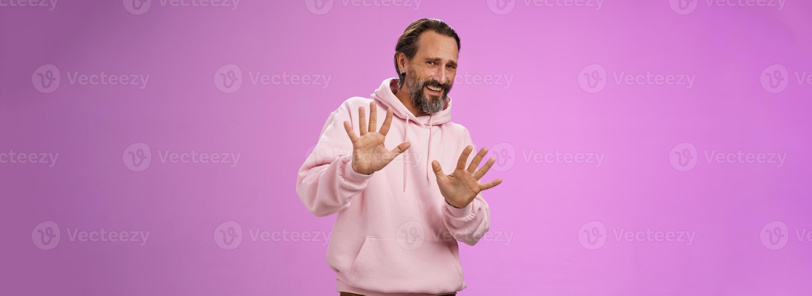 Stop no not come closer. Portrait awkward insecure afraid mature bearded man asking stop enough showing palms raised begging quit refusing step back displeased, standing unconfident photo