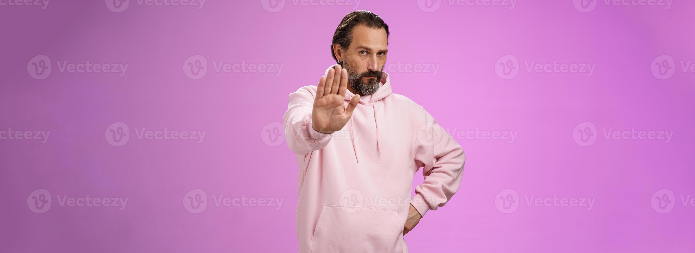 Stand right there. Portrait serious-looking bossy adult bearded father extend arm stop taboo no gesture forbidding come party look solid confident demanding quit, standing purple background photo