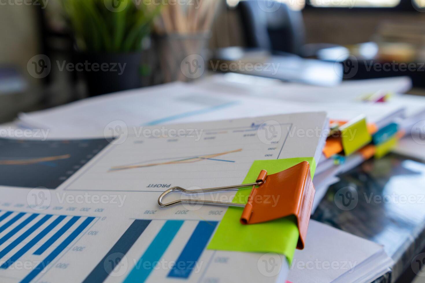 The pile of documents on the secretary's desk was prepared for the executives who would be attending the meeting. Several documents were stacked on the secretary's desk ready for the attendees. photo