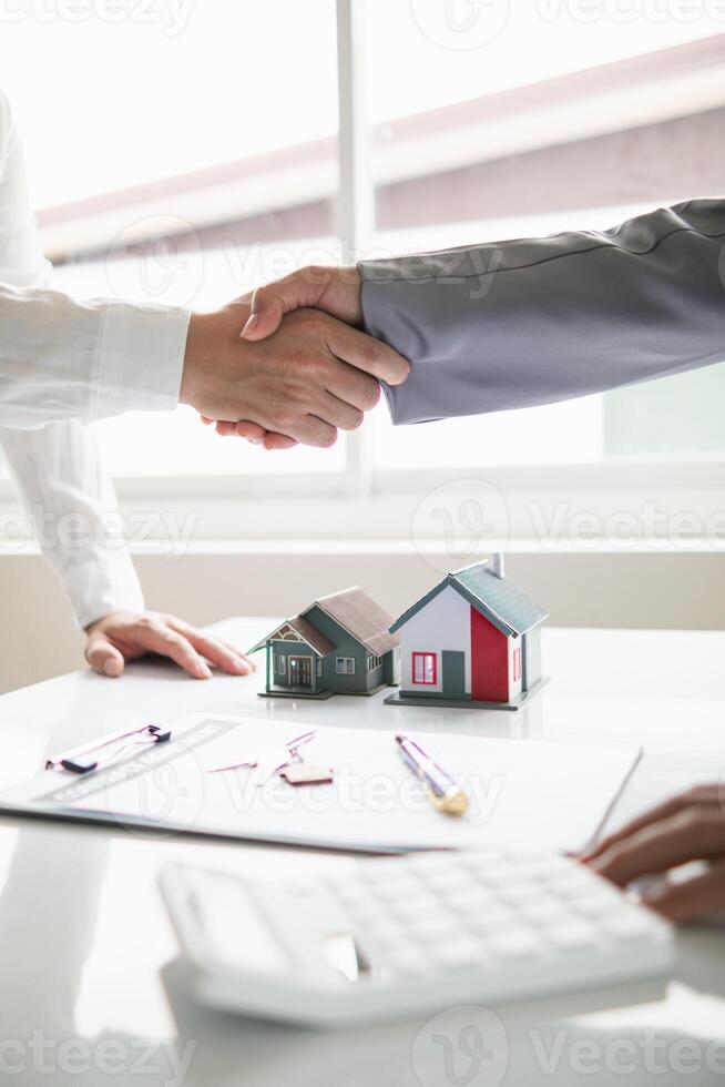 EV car dealers join hands with customers when they agree purchase an EV car from dealer and sign valid sale contract. Buyers have agreed lease-purchase EV car from dealers because they are effective. photo