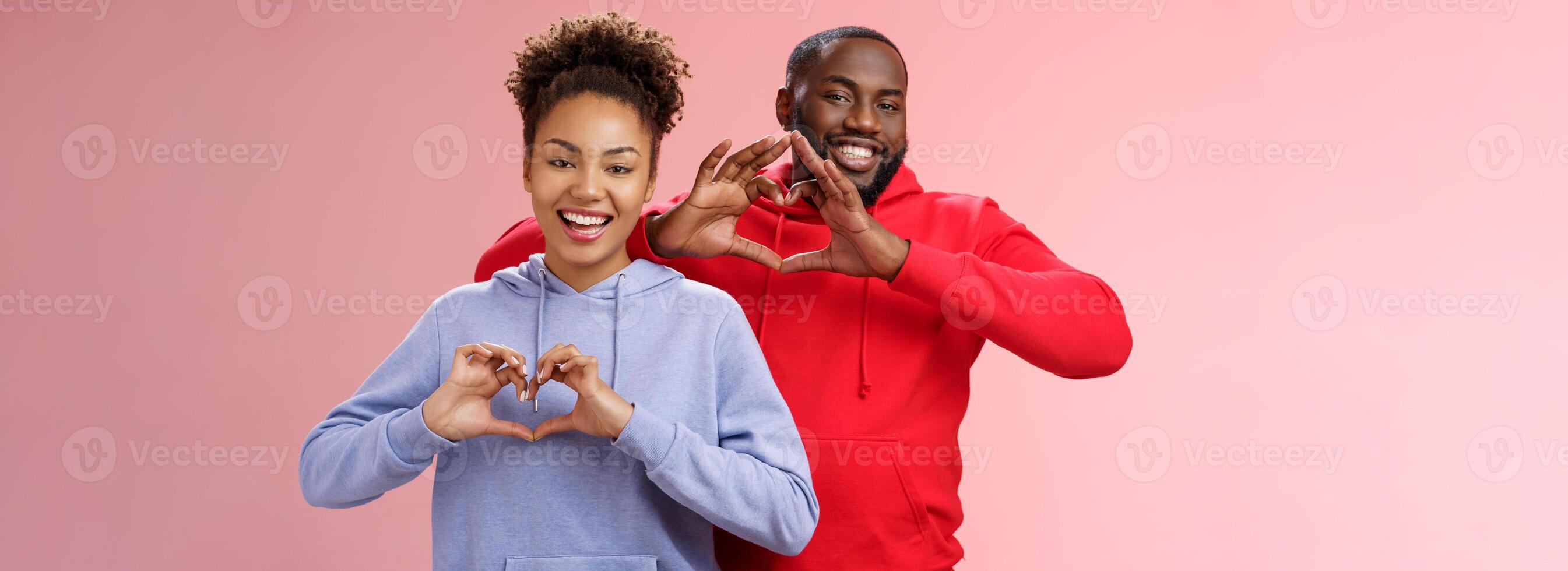 Charming joyful caring young african american family man woman siblings smiling broadly show heart gestures grinning express love empathy positivity, two loyal friends cherish friendship photo