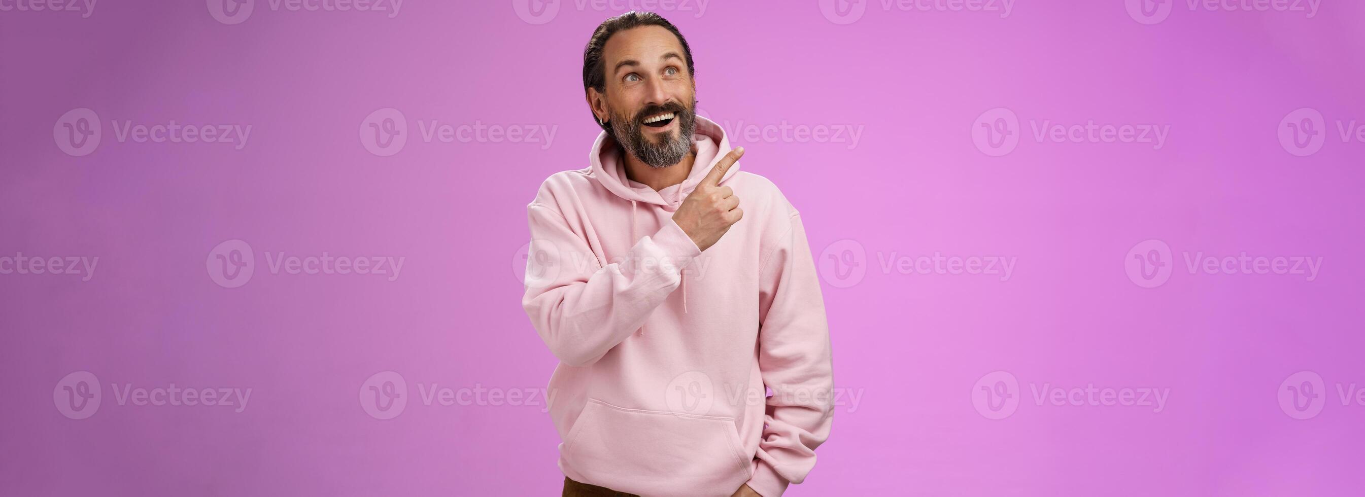 Fascianted joyful handsome mature 40s bearded husband attend interesting amusement park impressed pointing upper left corner enjoying weekend look surprised wondered, gazing alluring product photo