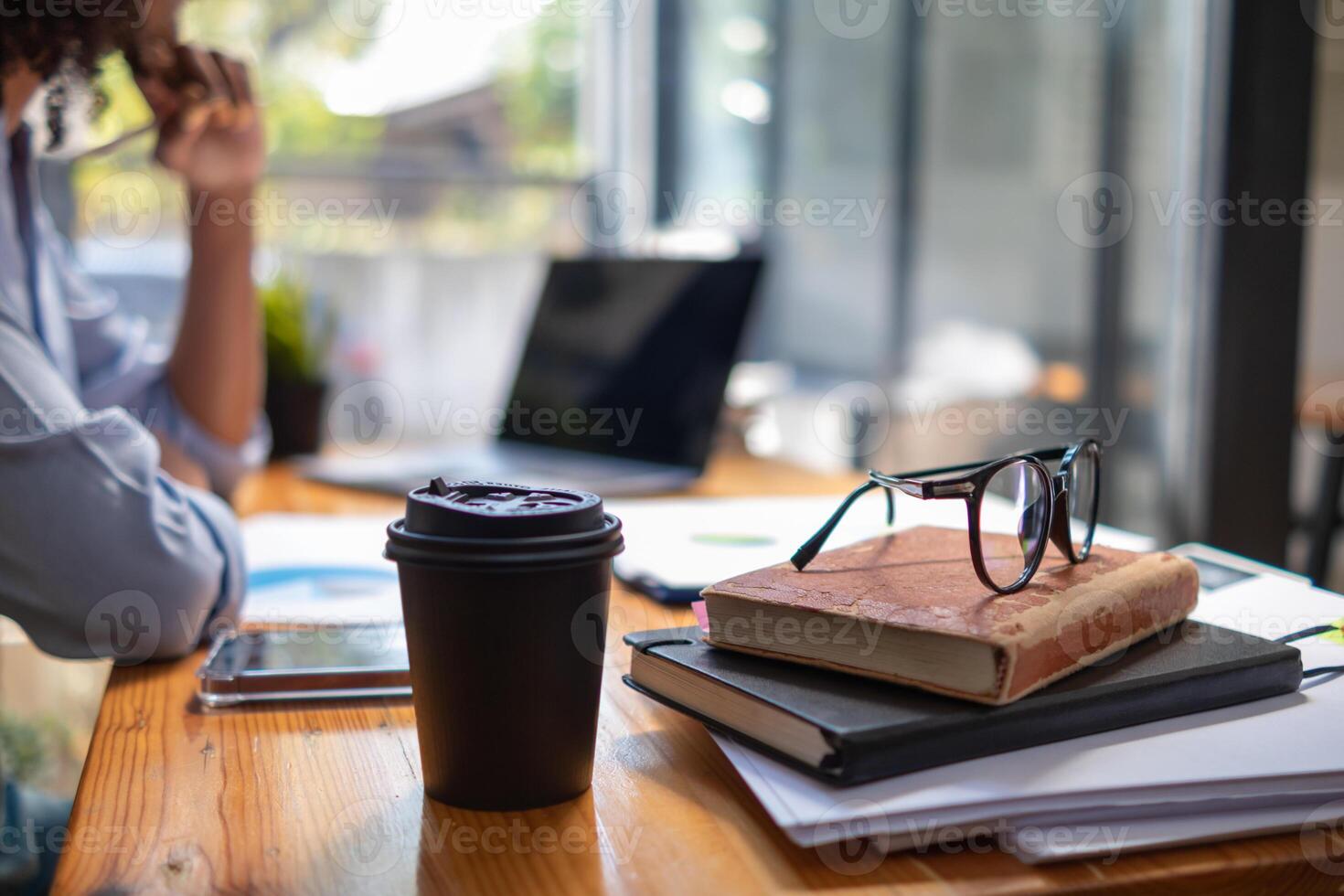 The pile of documents on the secretary's desk was prepared for the executives who would be attending the meeting. Several documents were stacked on the secretary's desk ready for the attendees. photo