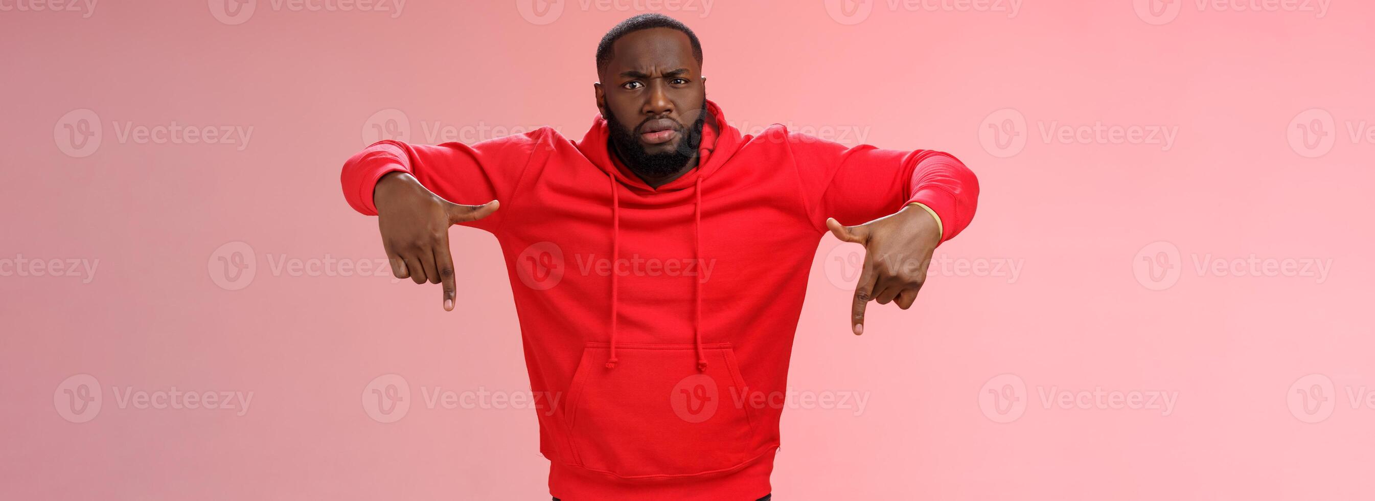 Questioned displeased pissed handsome serious-looking athletic black guy bearded frowning look perplexed wondered freak out pointing down waiting explanation, standing frustrated pink background photo
