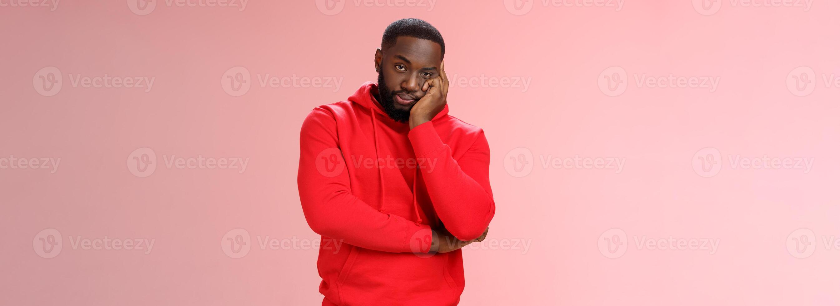 Bored annoyed african-american guy look sceptical dying boredom cannot wait go home lean head palm raise eyebrow judgemental ignorant, standing bothered irritated pink background photo