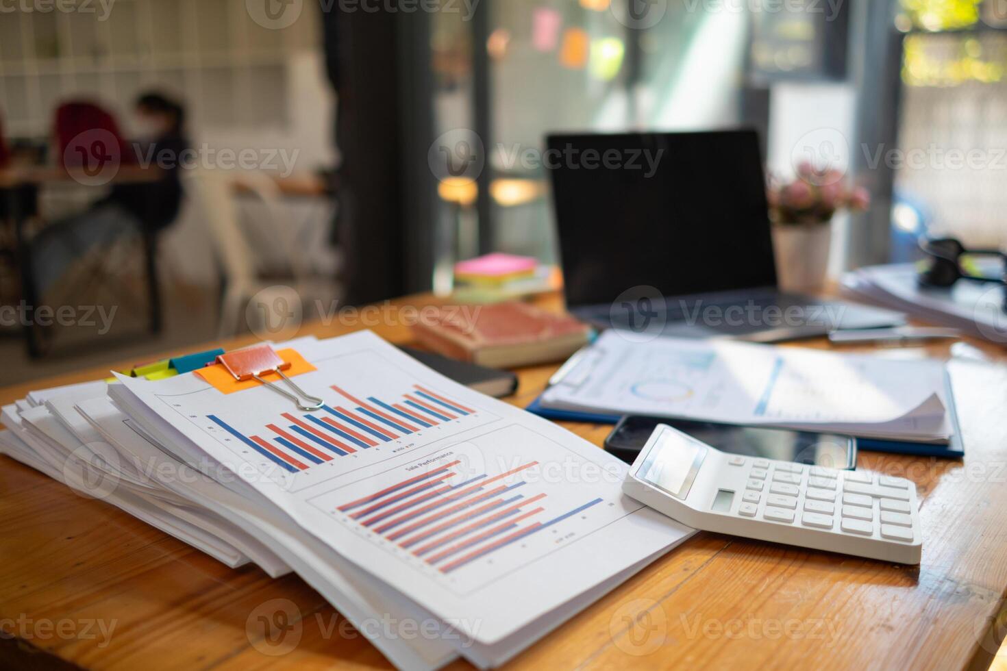 The pile of documents on the secretary's desk was prepared for the executives who would be attending the meeting. Several documents were stacked on the secretary's desk ready for the attendees. photo