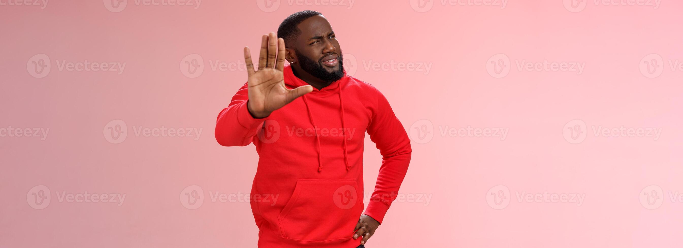 Hold on, stop right there. Portrait confused perplexed african american man cringing questioned raise hand enough shut up gesture arguing hear stupid nonsense, standing pink background photo