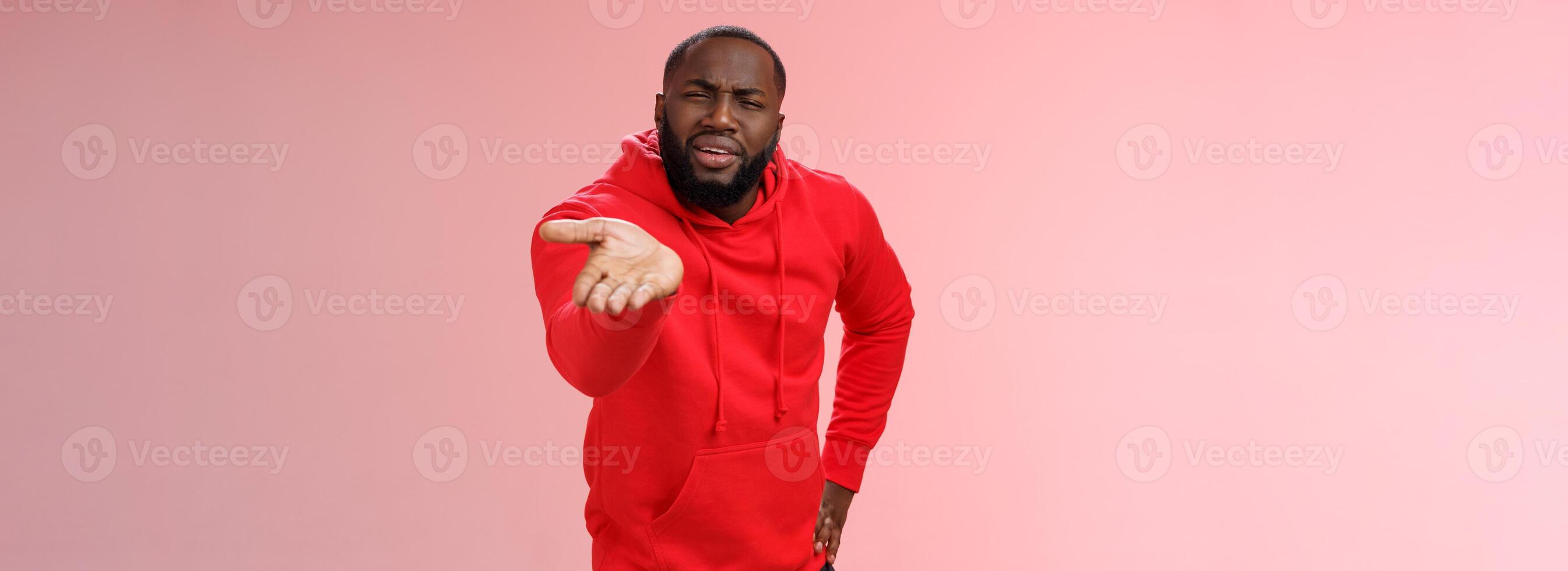 Displeased african-american man scolding friend acting bad asking what doing life pointing camera palm arguing standing disappointed judging mate outfit, standing pink background photo