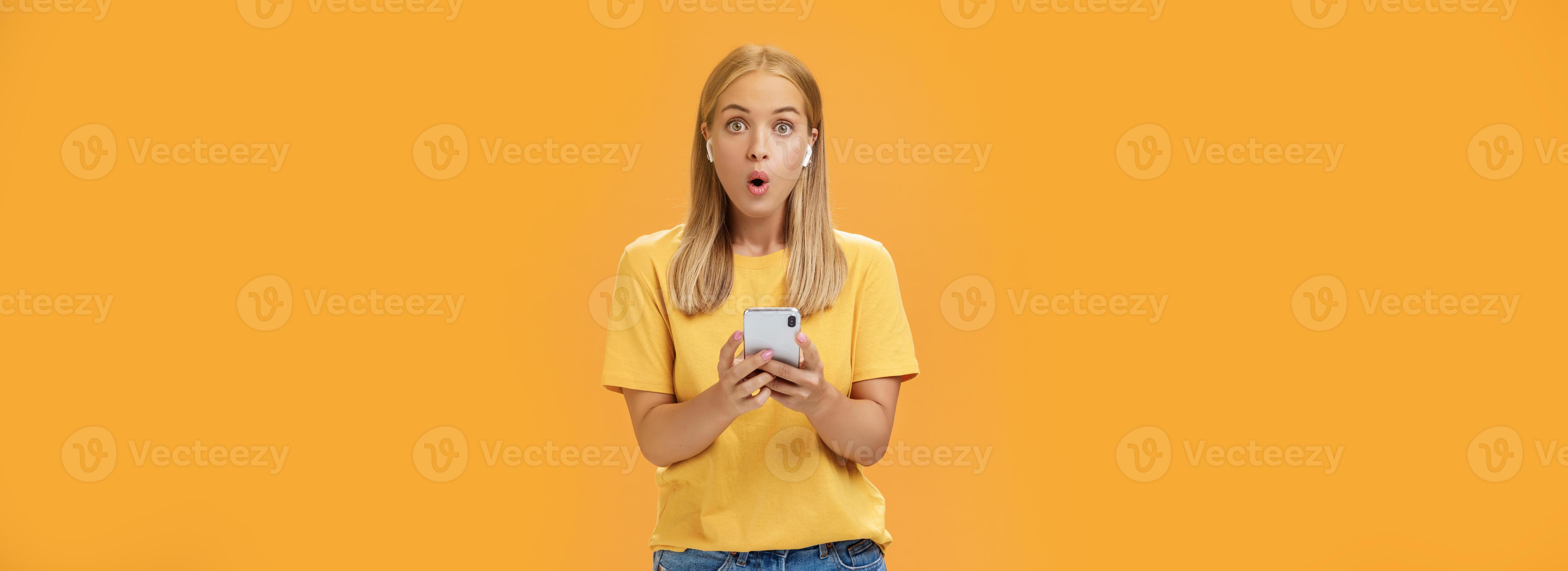 Woman surprised how awesome sounds new wireless earbuds holding Woman surprised how awesome sounds new wireless earbuds holding