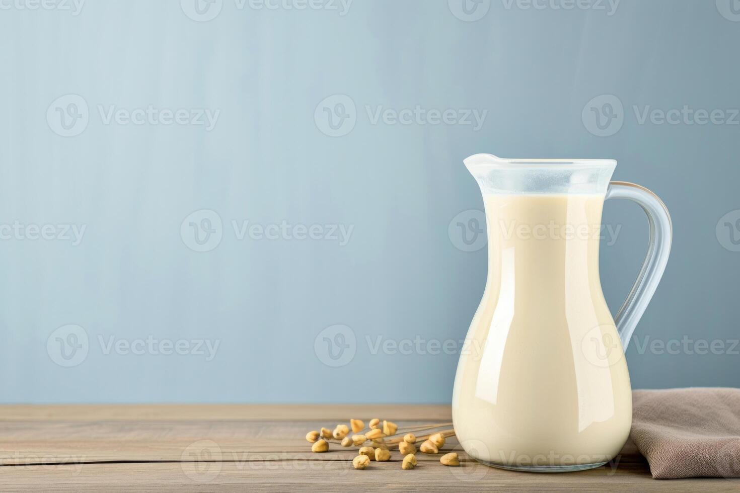 AI generated A glass and bottle of milk on wooden table with light blue background photo