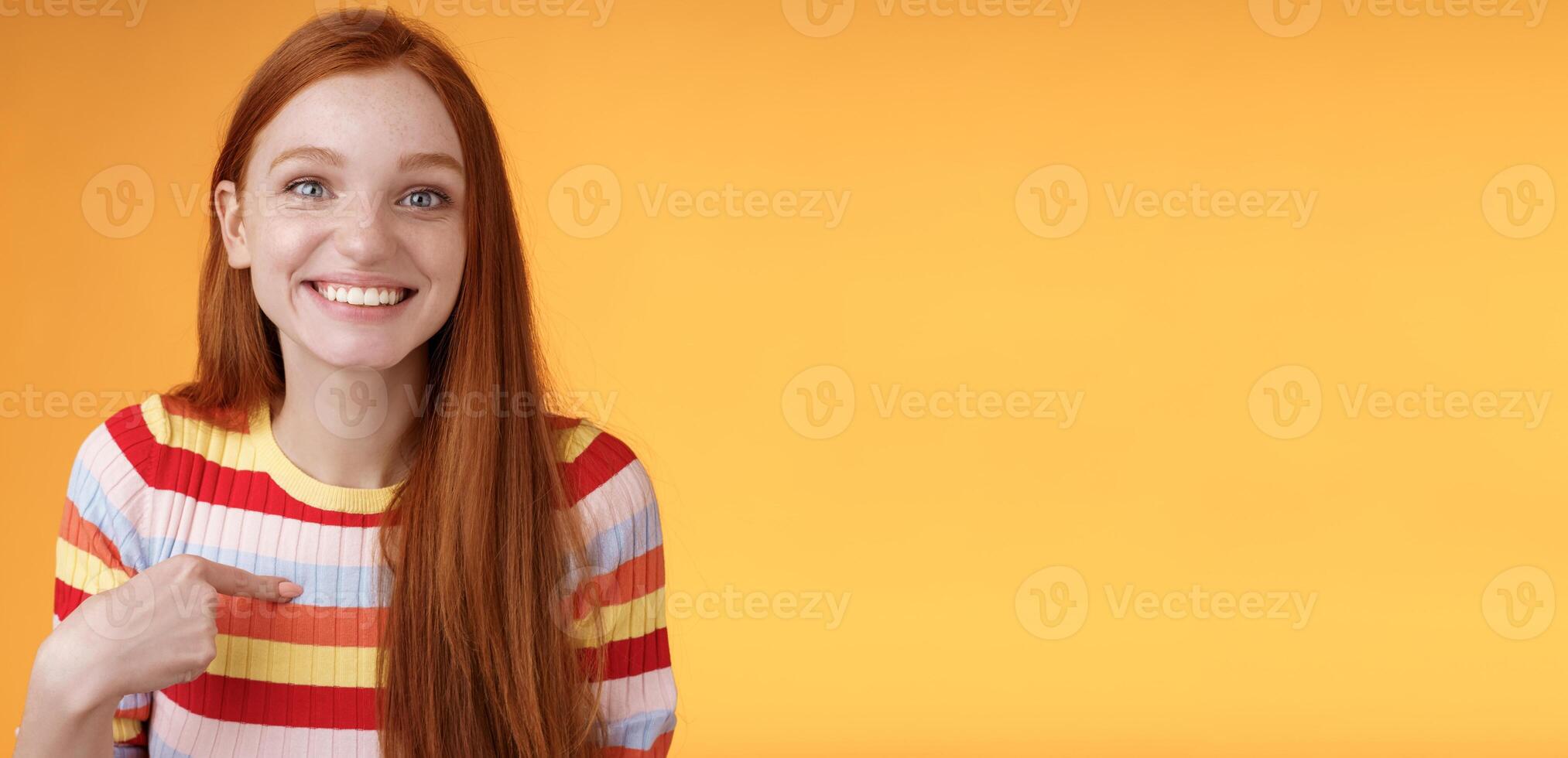 Happy excited grinning redhead girl chosen smiling gratitude delighted gladly pointing herself look surprise thankful camera got job, receive scholarship standing orange background photo