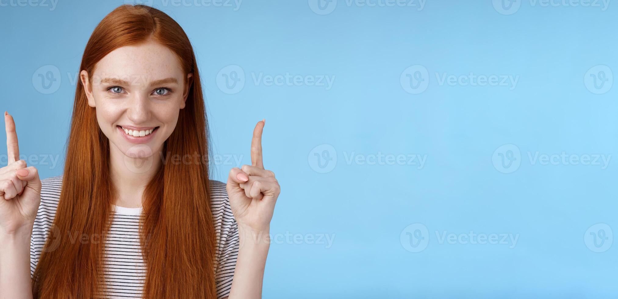Determined good-looking redhead female student enter college final decision pointing up index fingers raised confidently smiling white teeth look camera assertive giving recommendation what choose photo