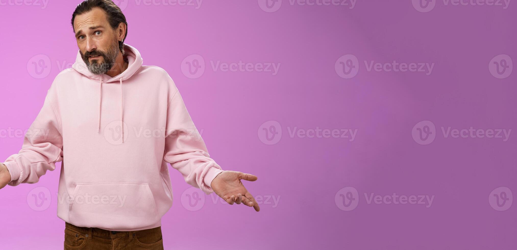 Nothing man could do. Mature bearded guy grey hair 40s spread hands dismay cannot help gesture frowning apologizing shrugging unaware standing perplexed not know anything, purple background photo