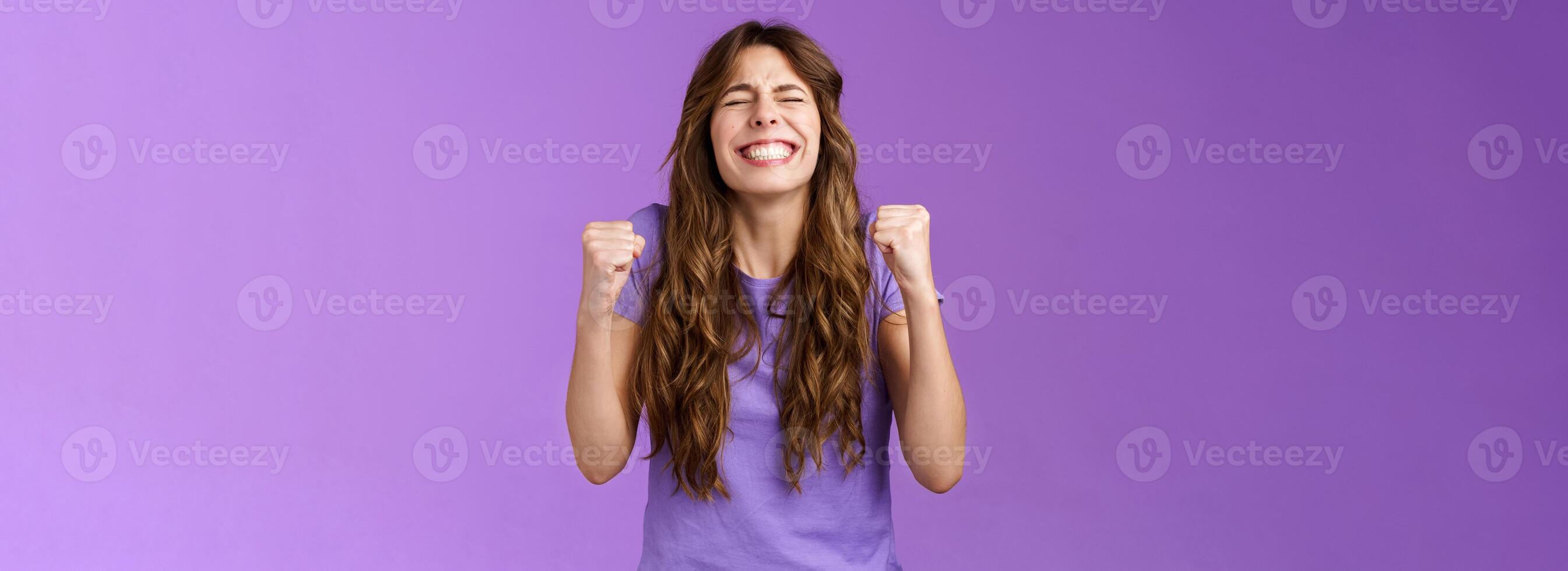 Yes I did it. Relieved happy triumphing joyful girl pump fists celebrating excellent achievement raise head up close eyes thank god winning first prize stand purple background happy photo