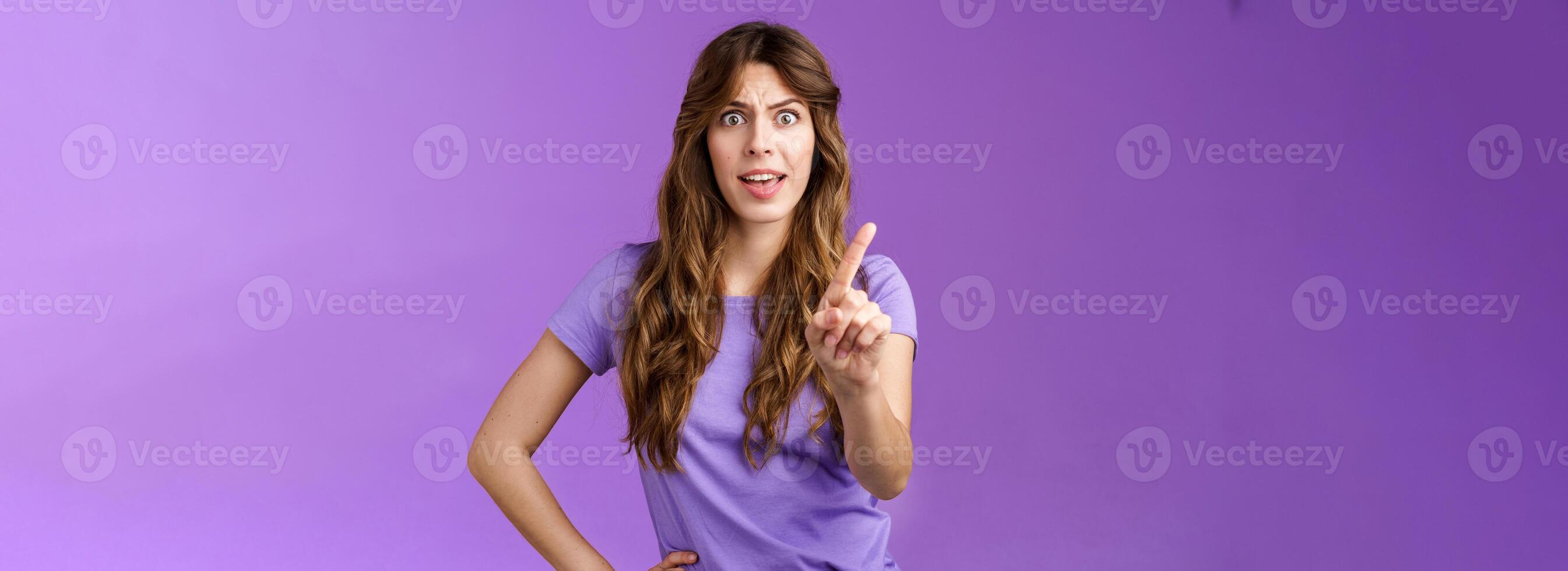 Displeased offended serious-looking assertive woman forbid express dislike and disapproval frowning annoyed shaking index finger prohibit refusing offensive behaviour stand purple background photo