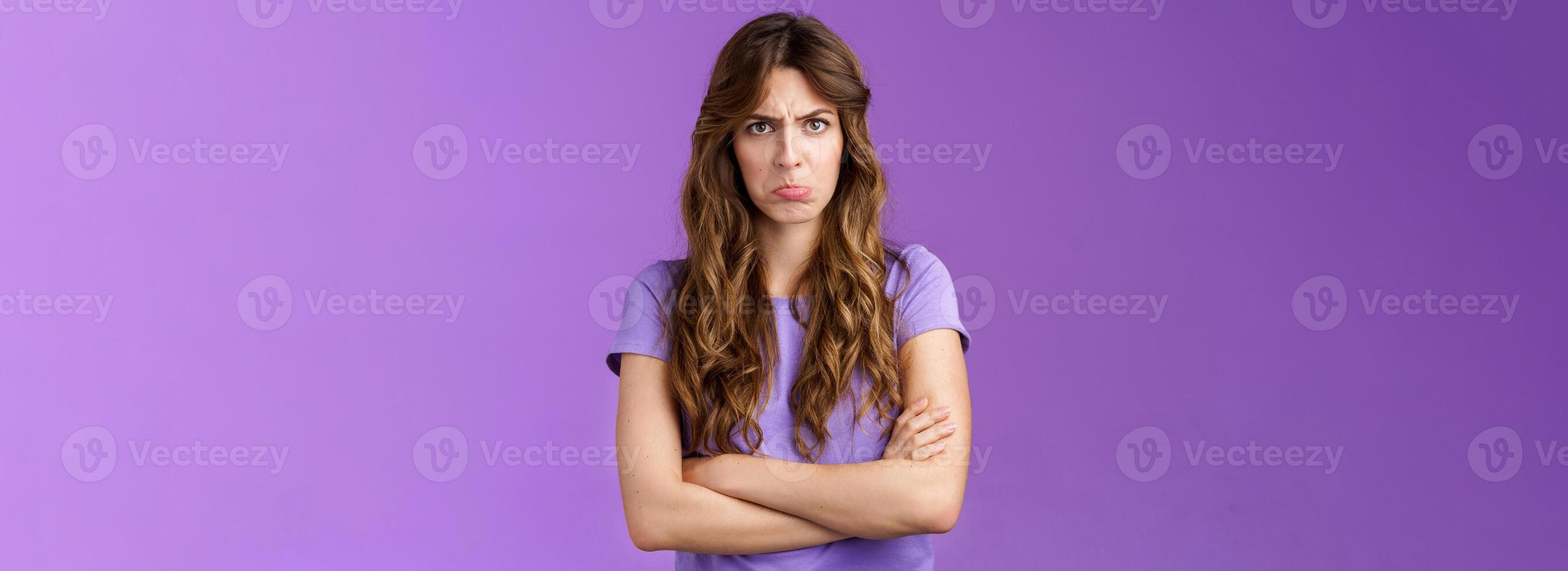 Offended silly timid cute girl sulking pouting lips frowning whining upset cross hands block pose insulted look moody camera disagree acting childish complaining unfair game purple background photo