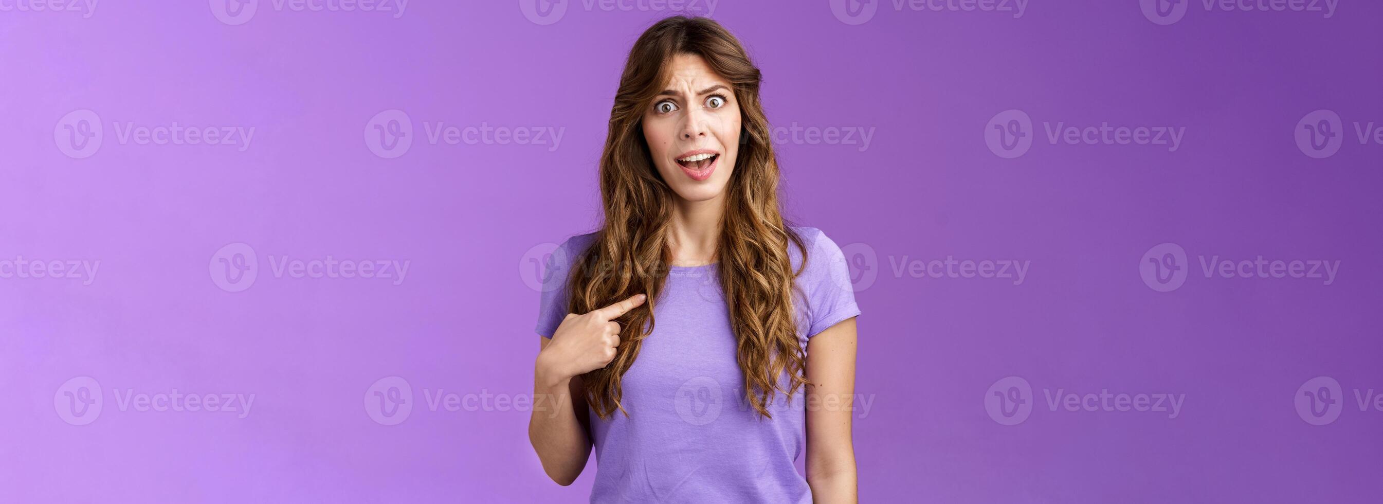 Accused frustrated upset shocked girl ambushed strange choice accusations pointing herself offended complaining frowning stand questioned displeased unfair decision purple background photo