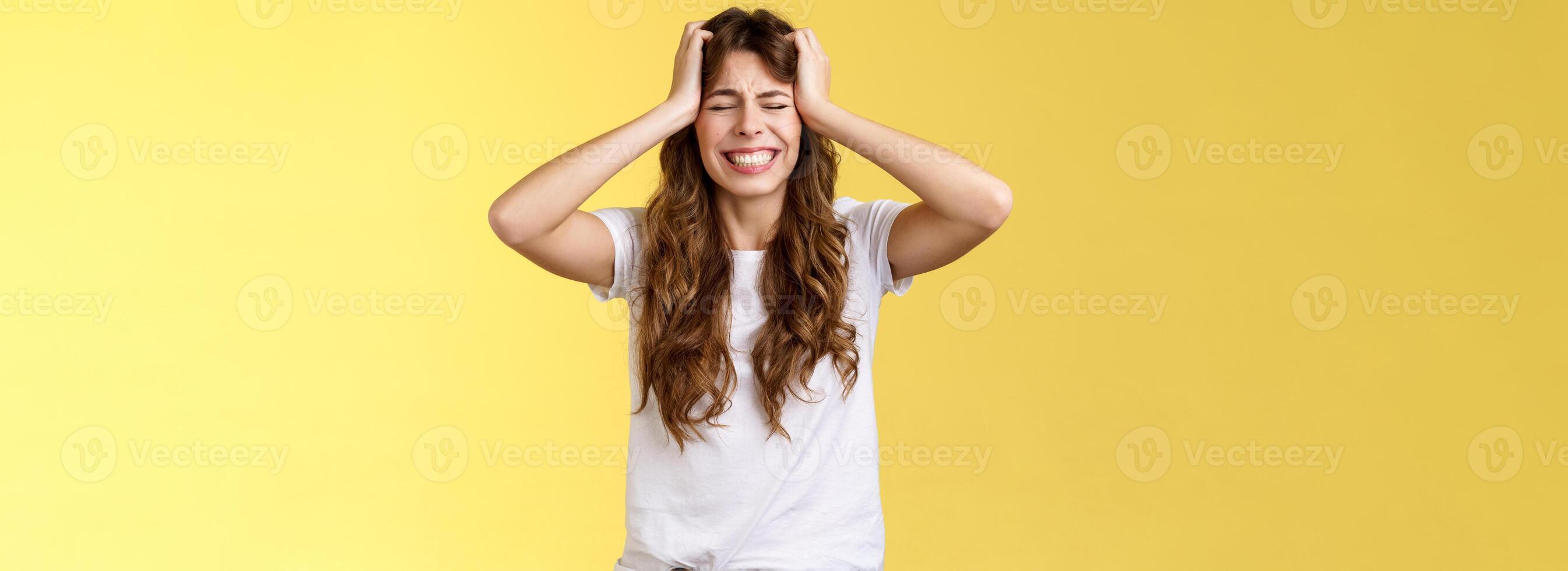 Girl feeling huge pain suffer heartbreaking break-up grab head panicking close eyes clench teeth anxiously troubled feel distress terrible situation stand yellow background hopeless grieving photo