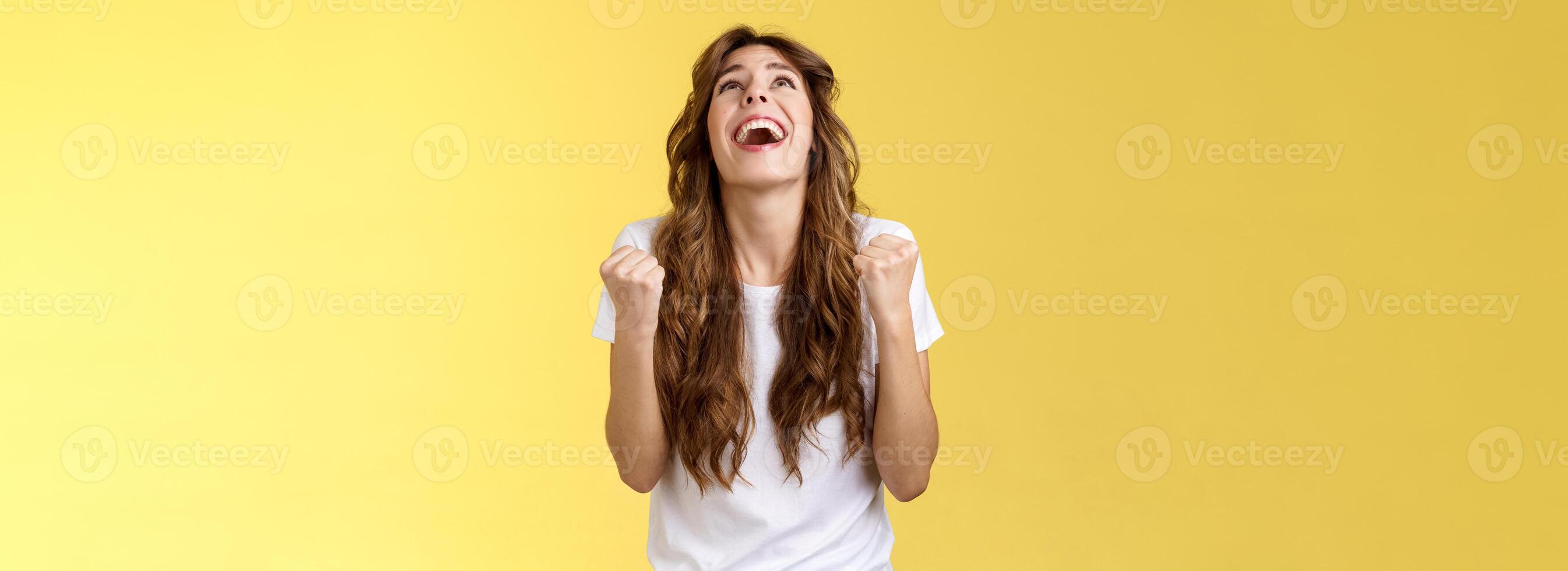 God finally yes. Relieved thankful pleased happy girl look up thank god fist pump celebration success win triumphing clench arms grateful delighted lucky opportunity stand yellow background photo