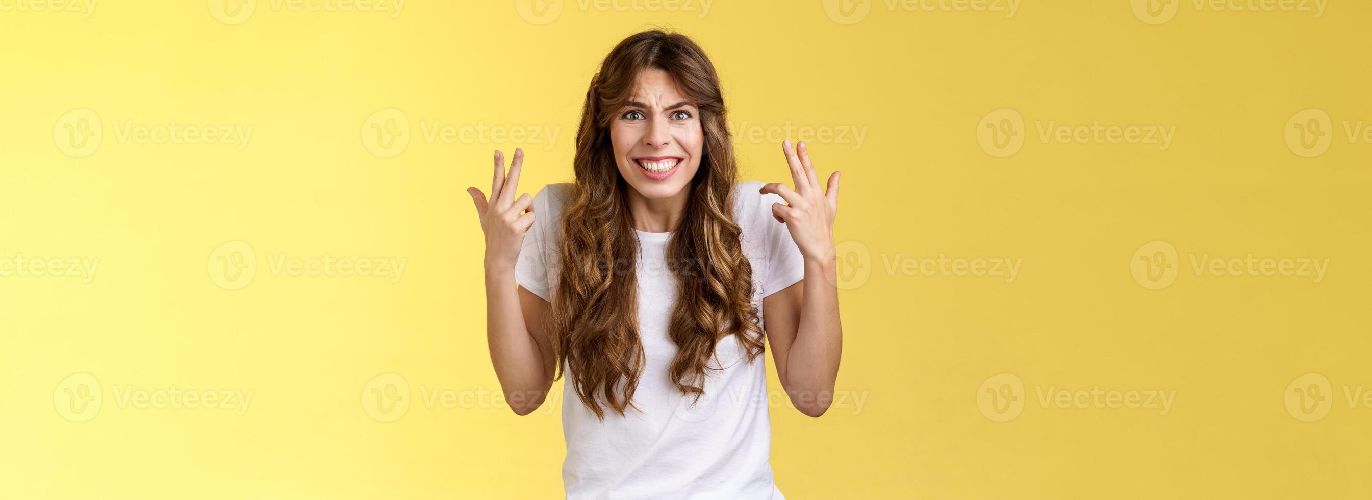 Pissed fed up angry freaked-out woman gesturing intense shaking hands furiously being outraged clench teeth frowning grimacing disappointed complain swearing cursing rude yellow background photo