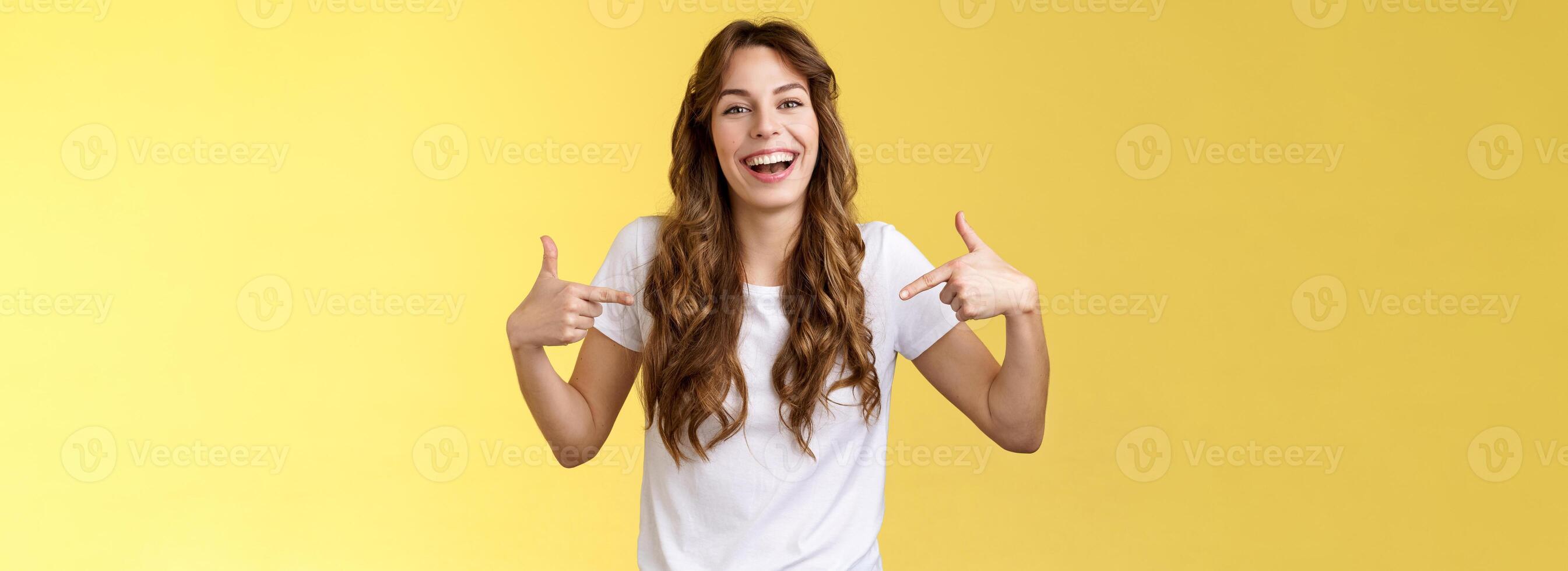 Haha awesome. Positive sincere attractive young woman curly long hair laughing joyfully pointing fingers center copy space white t-shirt chuckling having fun discuss great link show you promo photo