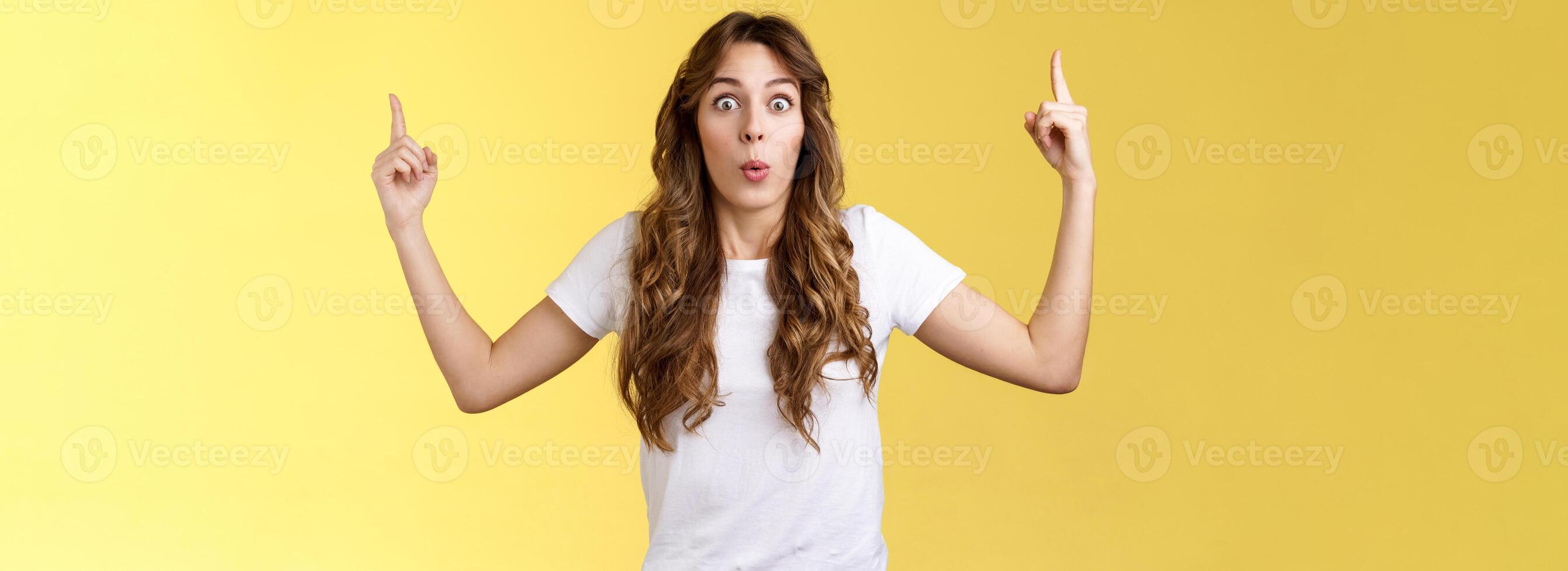Omg stunning promo look. Surprised astonished impressed good-looking girl stare camera excited react awesome promo raise index fingers pointing up telling you about incredible advertisement photo