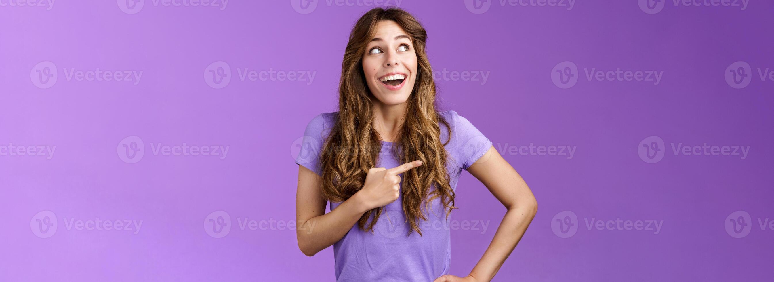 Dreamy wondered impressed cute lively excited positive girl feel happy travel abroad explore new city tourist trip smiling broadly contemplate awesome view look pointing left grinning purple wall photo