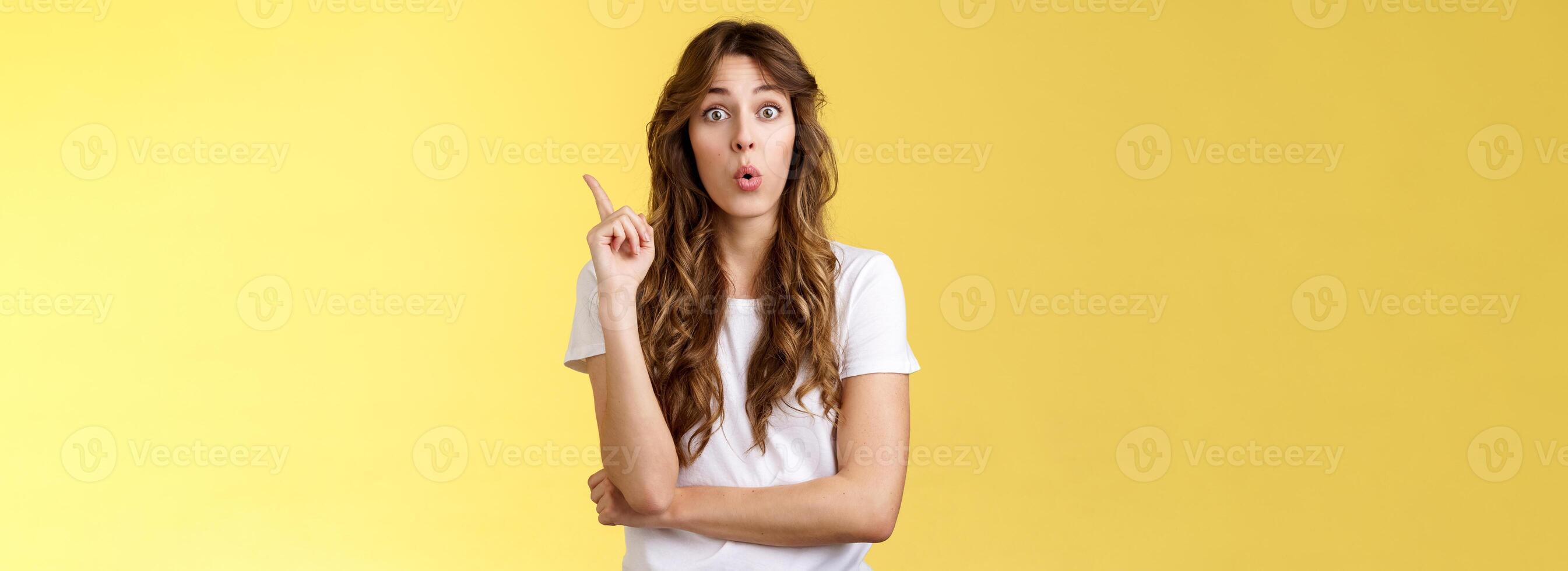 Great idea stiked mind. Ambushed creative good-looking female coworker give advice raise index finger eureka gesture fold lips intrigued speak out interesting plan thought stand yellow background photo