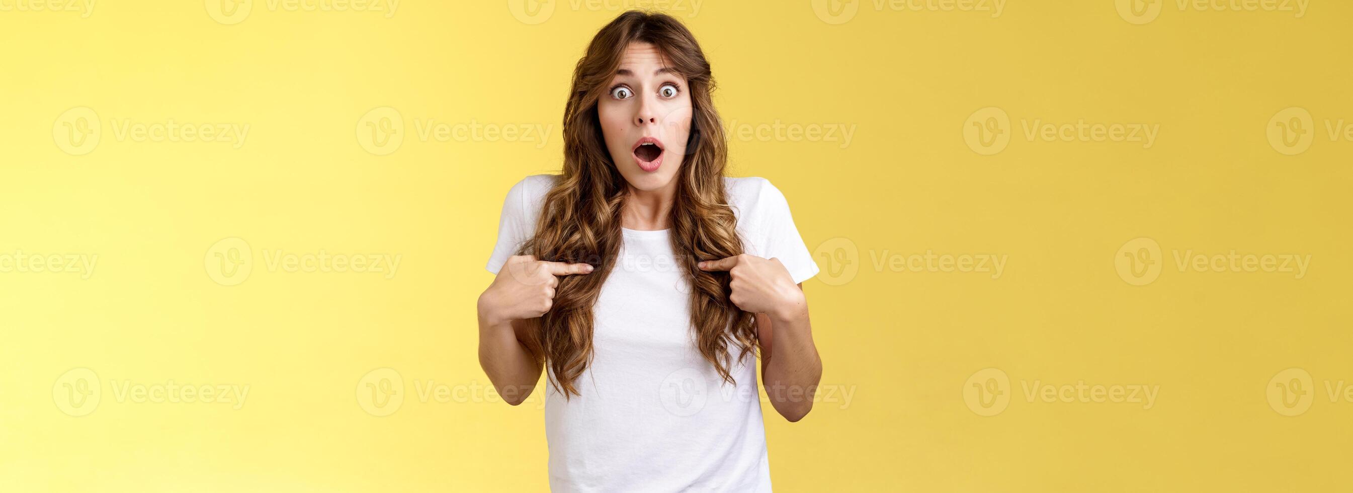 Shocked impressed speechless surprised girl gasping drop jaw pointing herself chest stare camera astonished unexpected promotion being chosen picked winning lottery stand yellow background photo