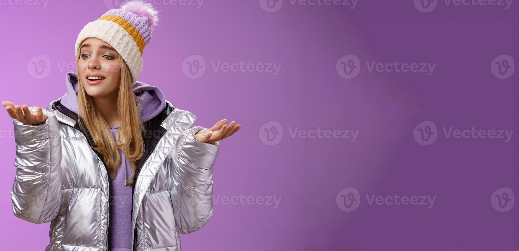 Delighted caring lovely young blond woman looking snowflake drop palm glancing hand tenderly smiling cherish nice moment enjoying winter snowy day standing pleased purple background photo