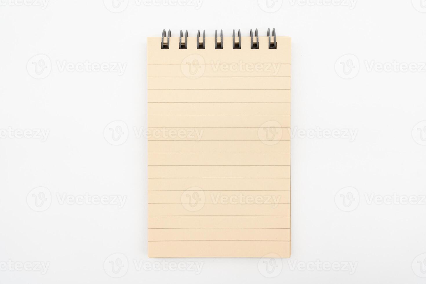 Spiral notepad in isolated background. Blank one face brown paper note. empty sheet of brown lined papers. photo