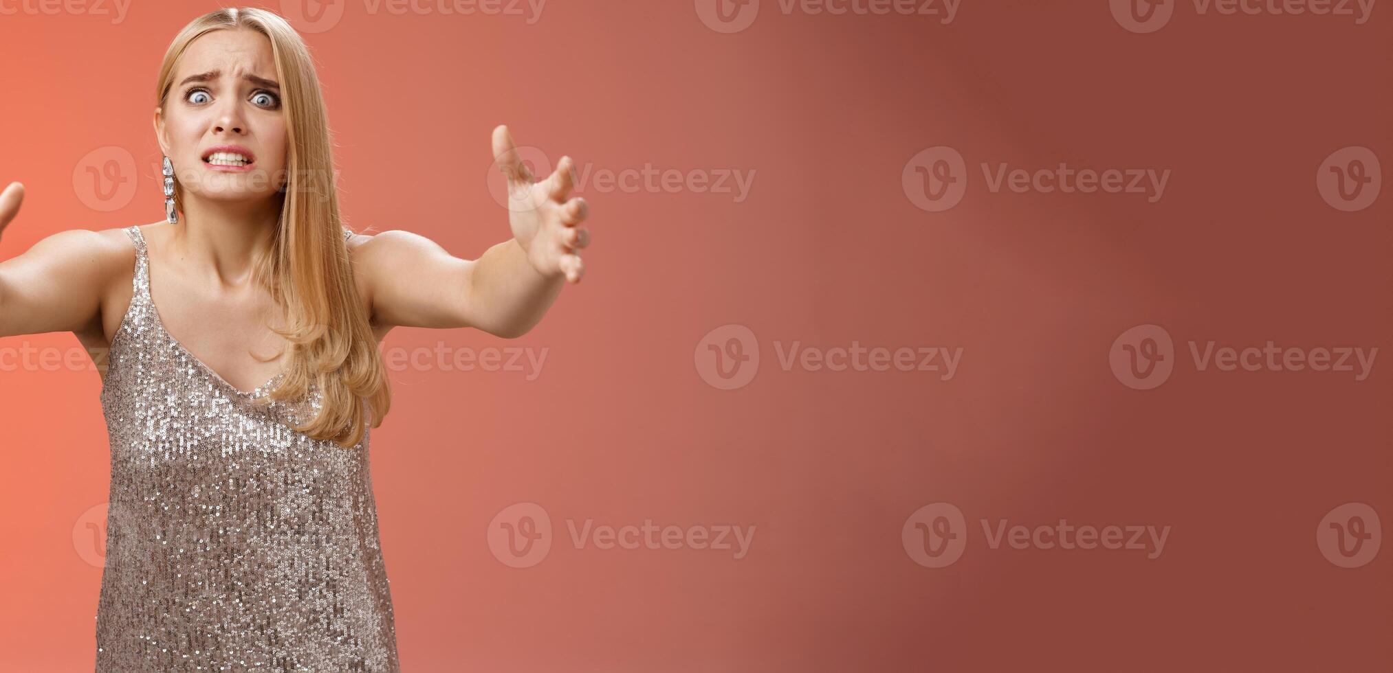 Obsessed ex-girlfriend widen eyes crazy clench teeth stretch hands forward wanna hold tight forever together standing crazy weird red background in silver dress clingy girl want hugs, cuddles photo