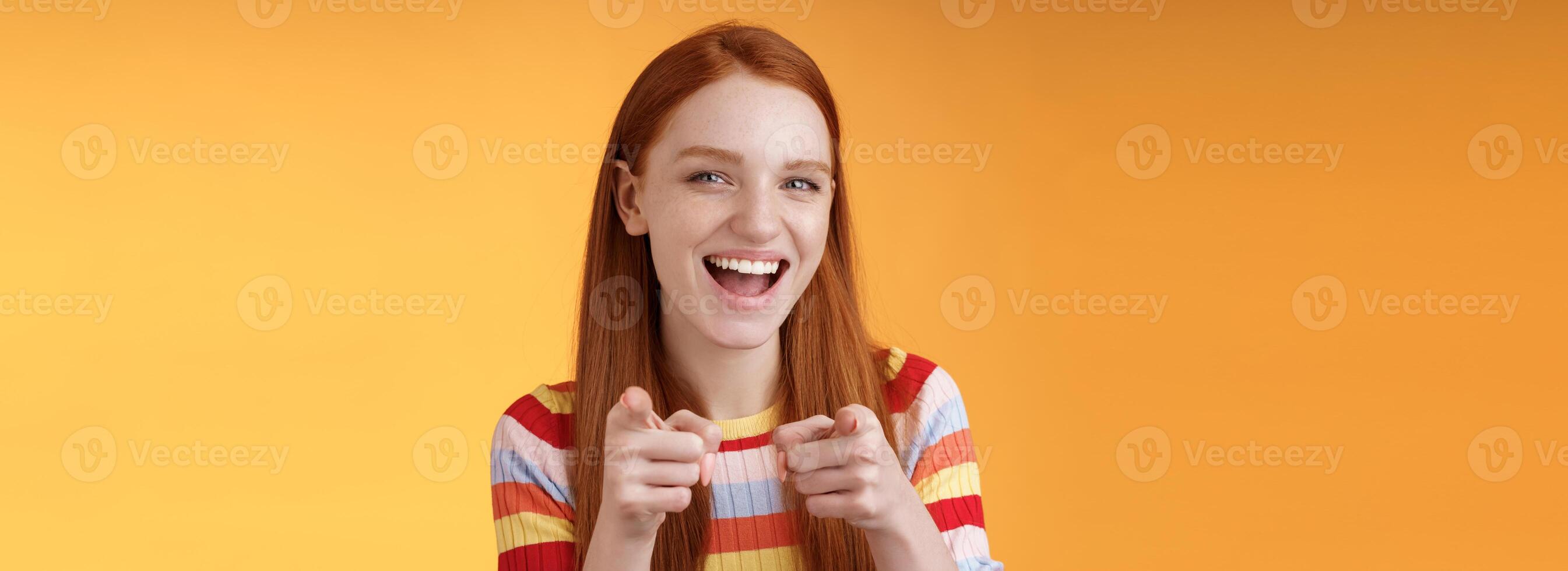 Enthusiastic carefree friendly redhead girl pointing finger-pistols camera smiling joyfully congratulating friend awesome choice cheeky greeting hinting girlfriend caught good opportunity photo