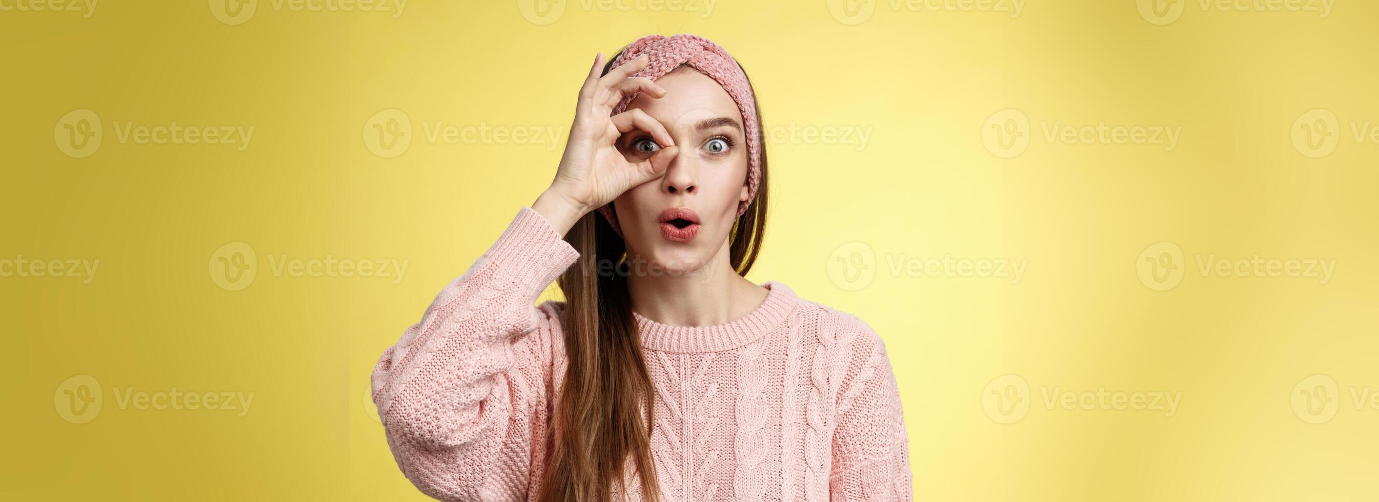 Girl looking through circle from hand amazed, excited folding lips amused and thrilled of awesome incredible promotion, holding okay over eye, seeing good opportunity standing intrigued, interested photo