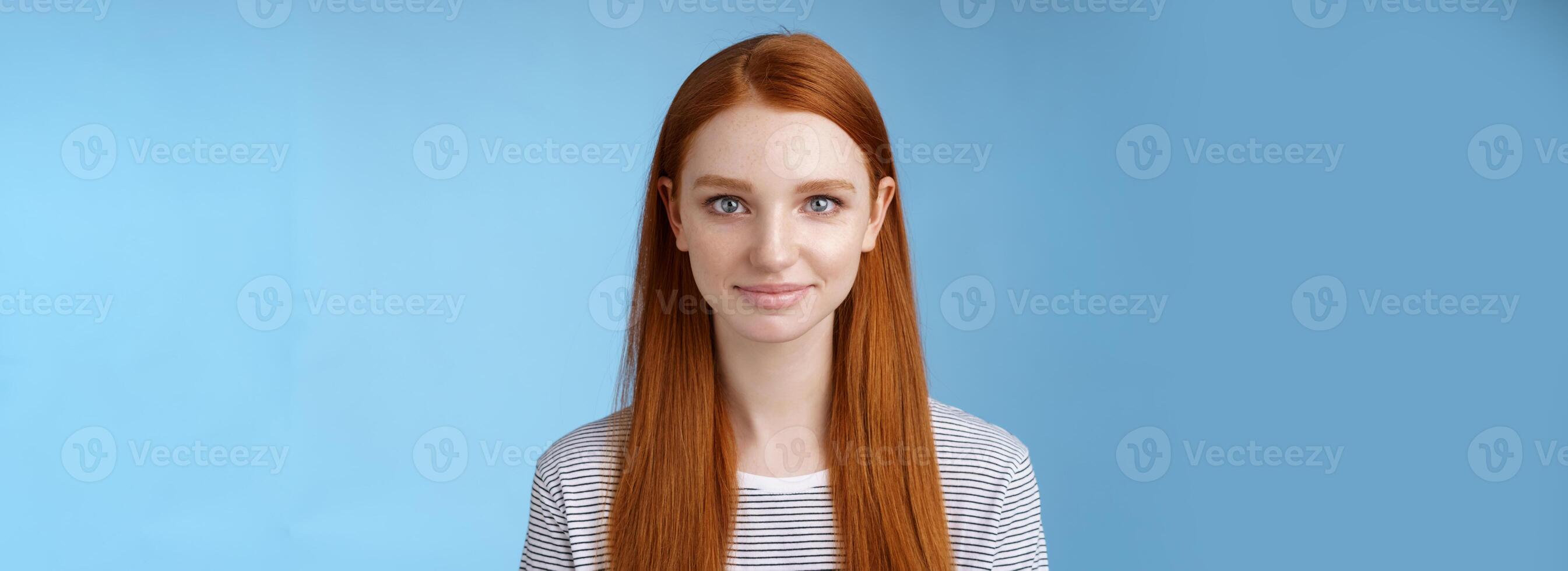 Excited good-looking confident young dreamy redhead girl blue eyes aimed success determined get job attend interview standing self-assured smiling friendly encourage herself, blue background photo