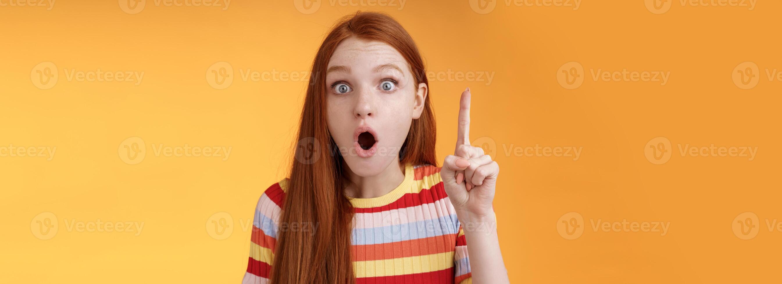 Wow got excellent idea. Excited shocked redhead girl open mouth raise index finger eureka gesture stare camera thrilled adding suggestion have plan think-up solution, standing orange background photo