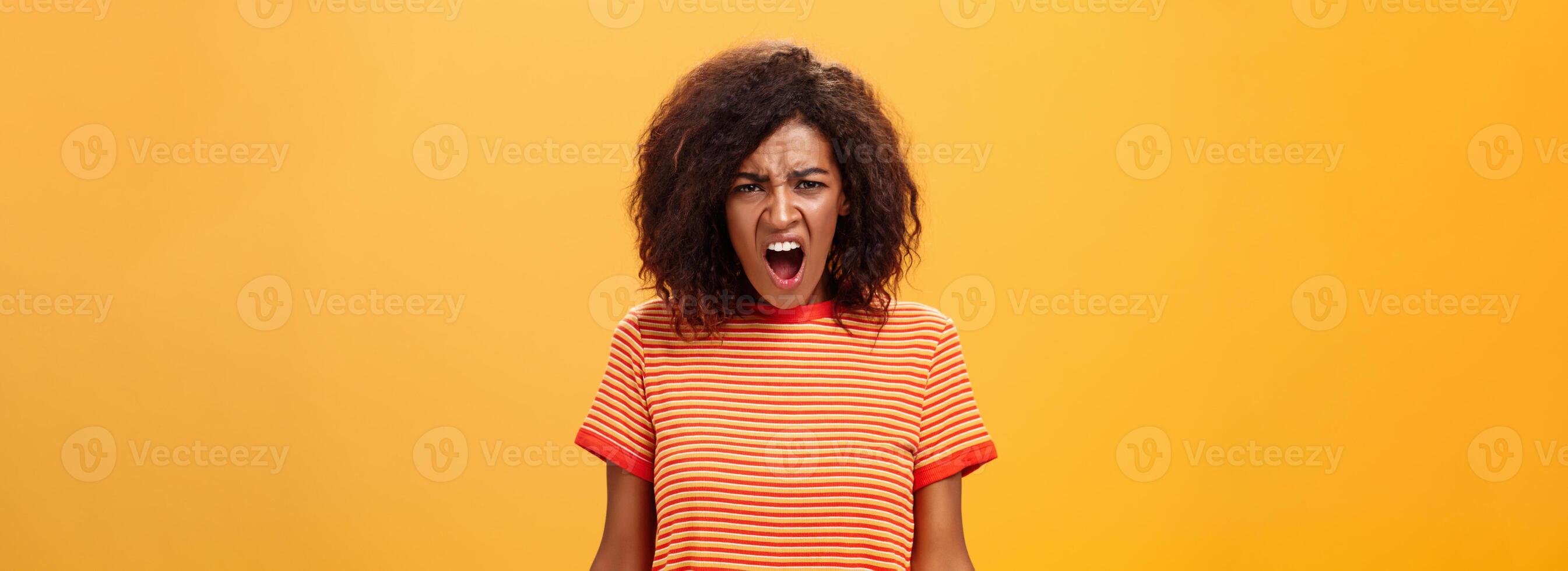 Not fair you broke promise. Portrait of offended displeased moody african american girlfriend with curly hair yelling and complaining making displeased grimace shouting at camera from offence photo