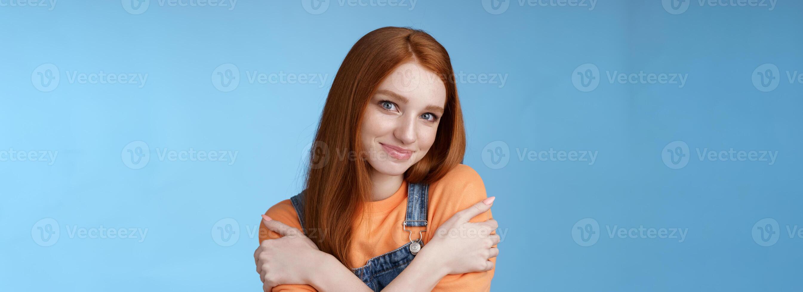 Romantic sensitive flirty young redhead girlfriend feel warmth embraces hugging herself hands crossed body tilting head smiling safe gentle, dreaming lovely date recalling sensual moments photo