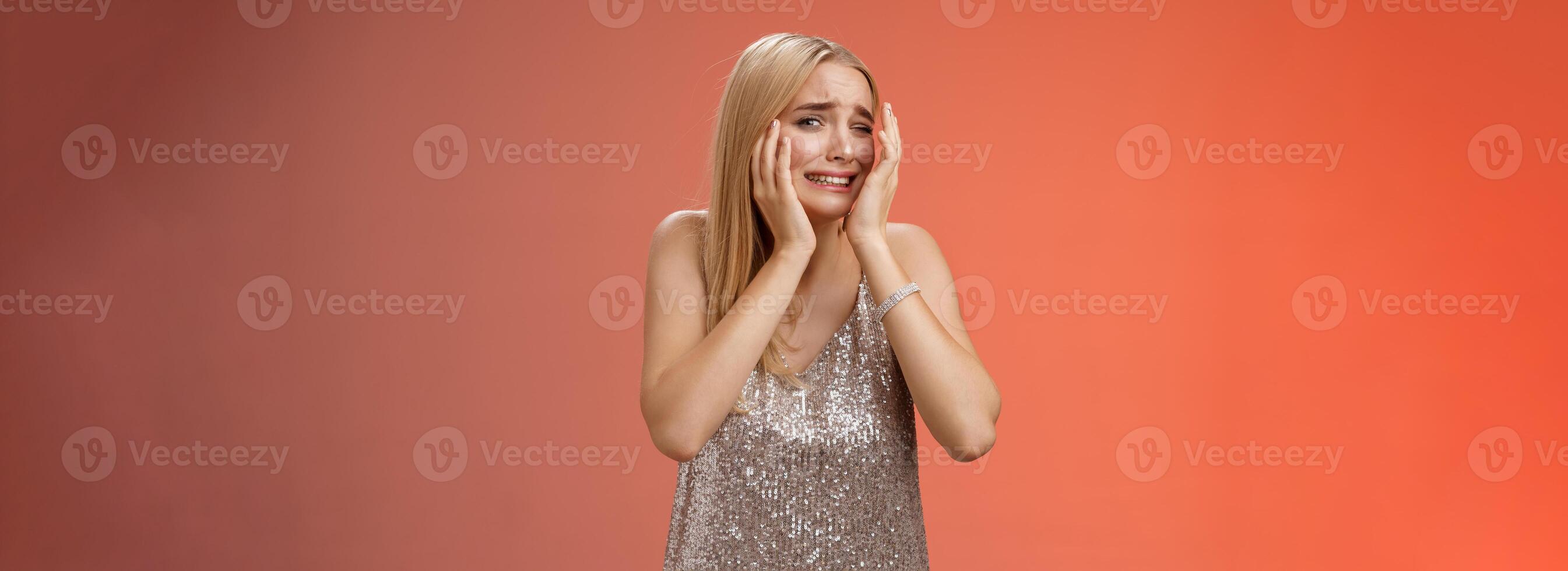 Concerned blond girlfriend panic feel afraid insecure unsafe anxiously turning face cover head look lost frightened assault victim in nightclub scared standing terrified in silver dress photo