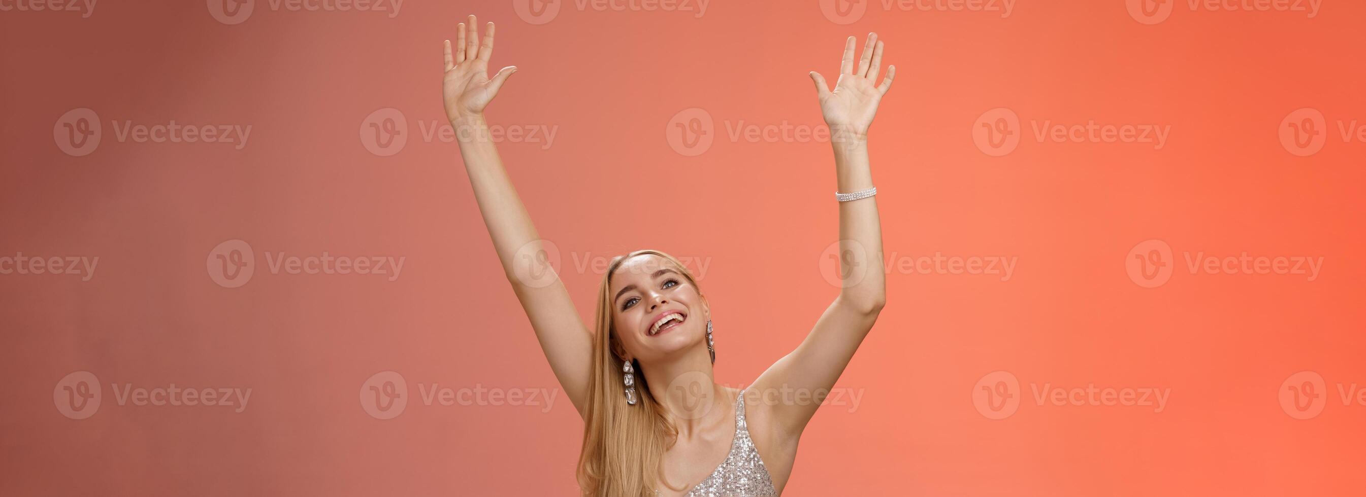 Girl dancing having fun standing fan-zone party enjoying awesome concert favorite singer in silver glittering elegant dress raise hands up waving palms moving music rhythm smiling delighted photo
