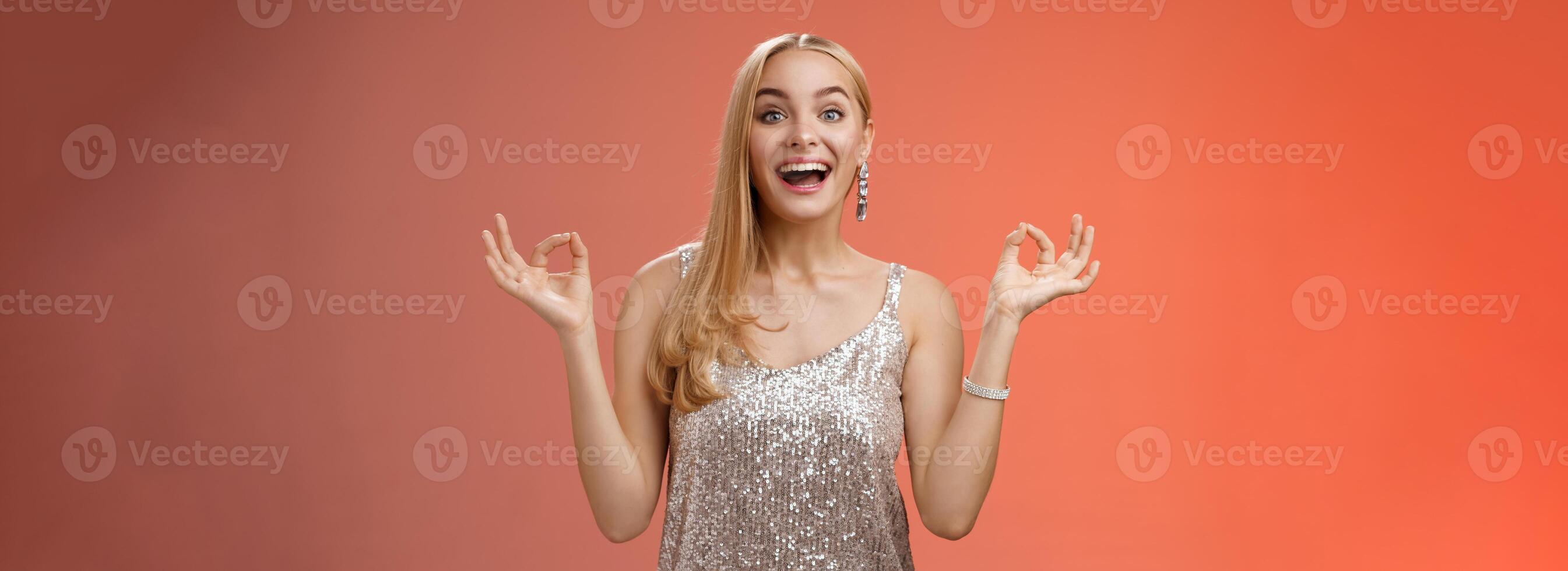 Excited carefree happy stress-free charming blond european woman calm feelings under control show zen gesture standing nirvana lotus pose meditating joyfully smiling, calmd-down red background photo