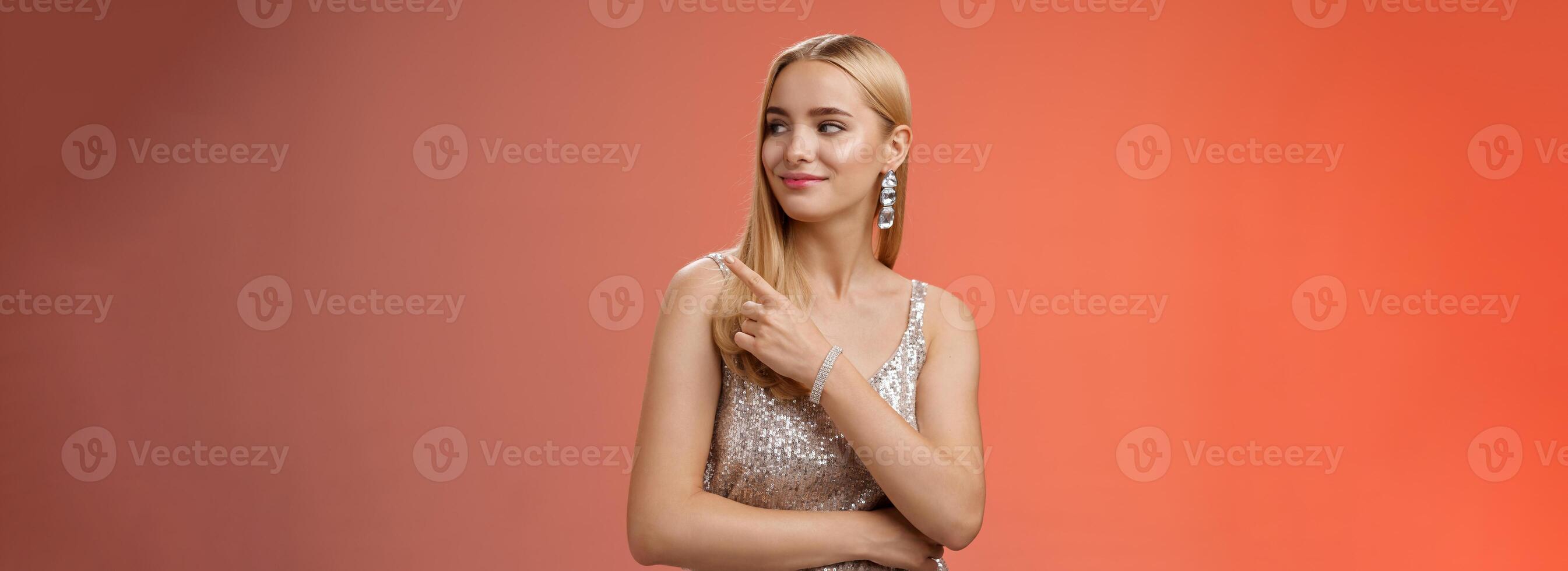 Confident tender carefree charming blond girl party in silver shiny glamour dress pointing looking right assured delighted point bar boyfriend order drinks nightclub, standing red background photo