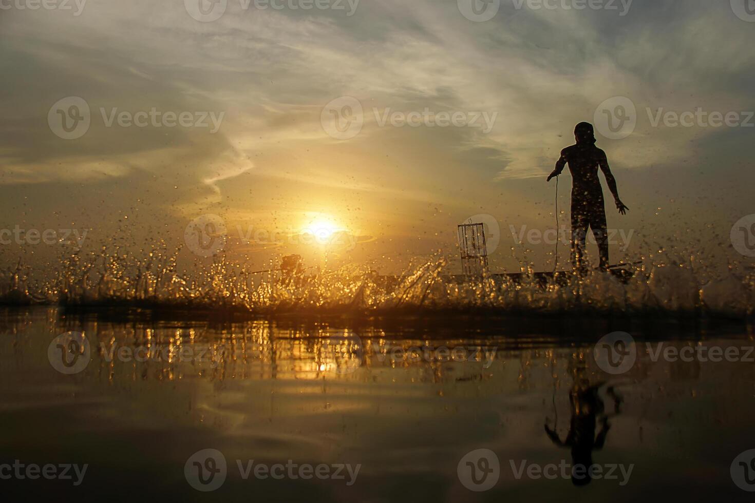 Silhouettes fisherman throwing fishing nets photo