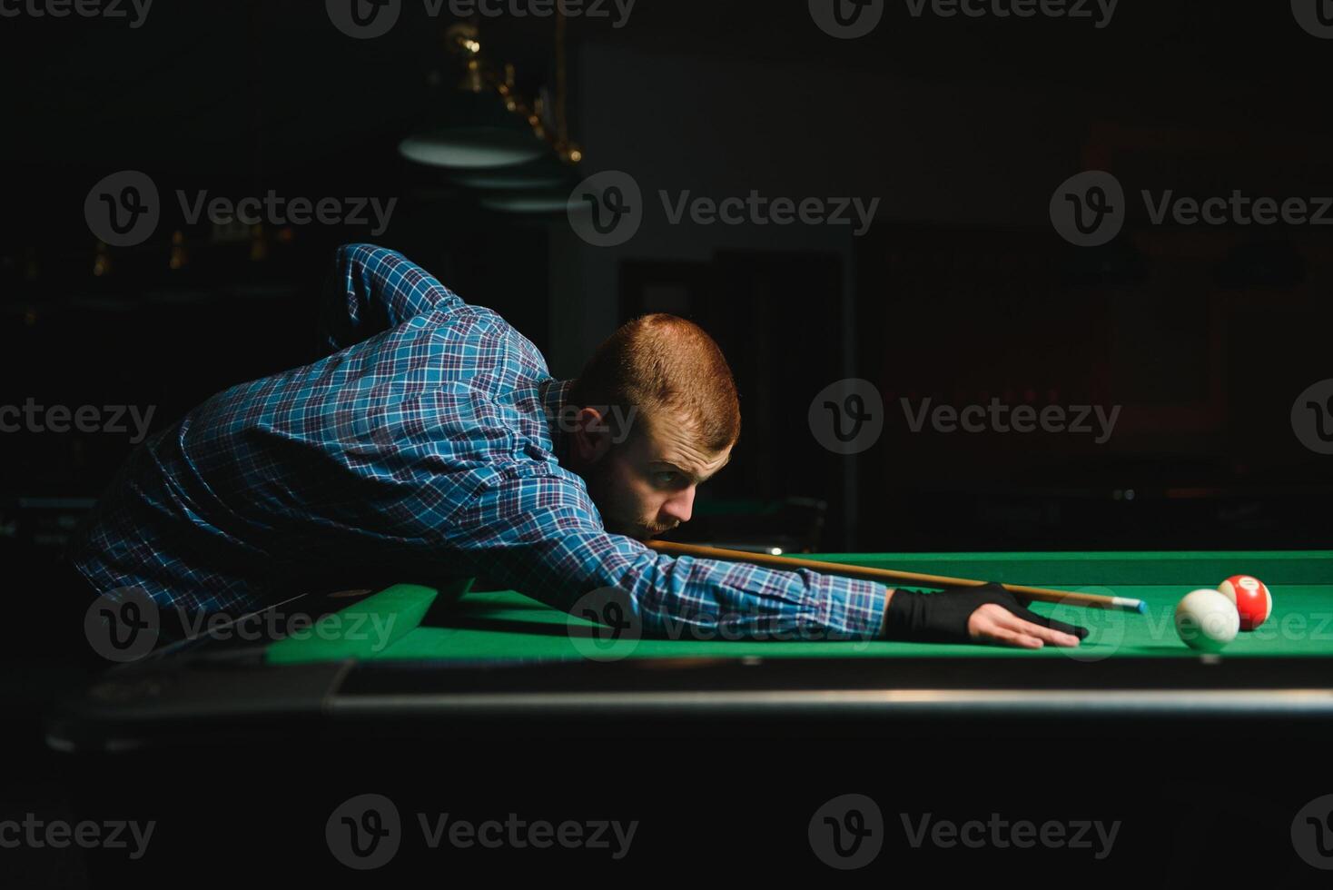 Playing billiard - Close-up shot of a man playing billiard photo