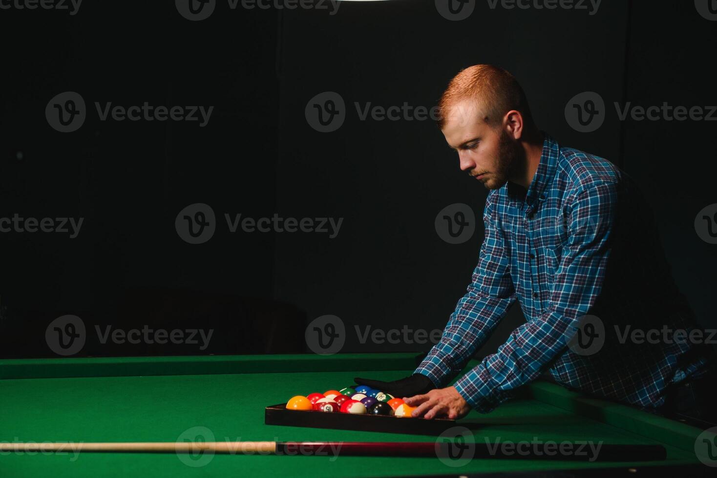 Playing billiard - Close-up shot of a man playing billiard photo