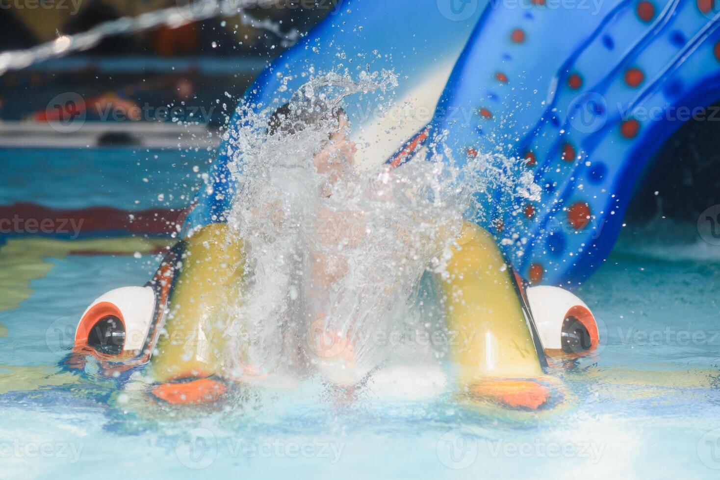 The boy is rolling with a water slide at a water park in Little Rock photo