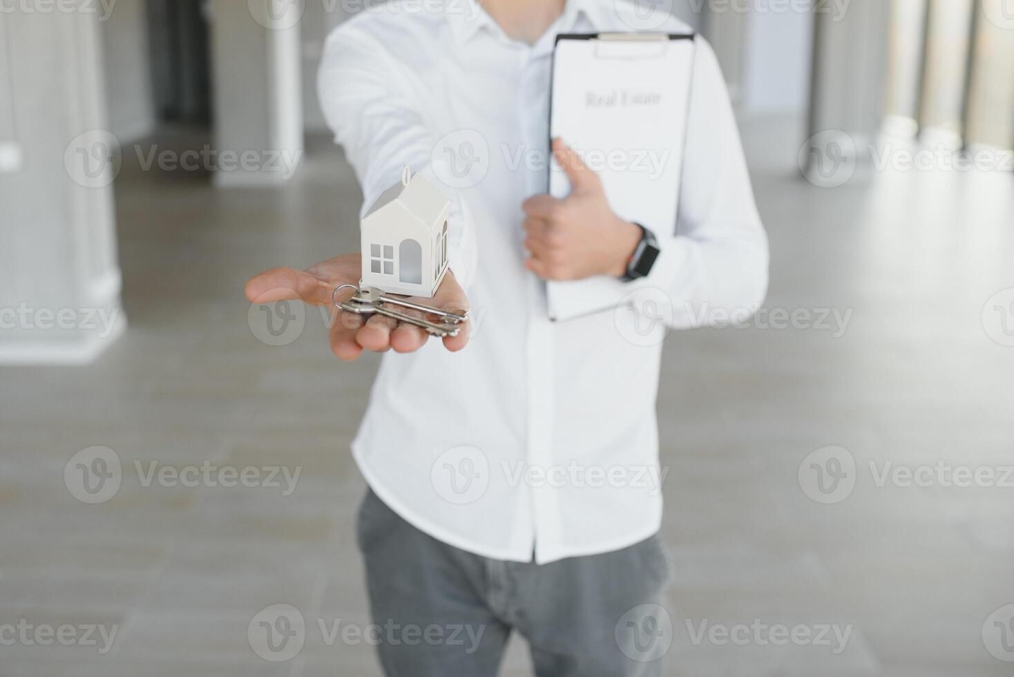 Male real estate agent with key in room. Banner for design photo