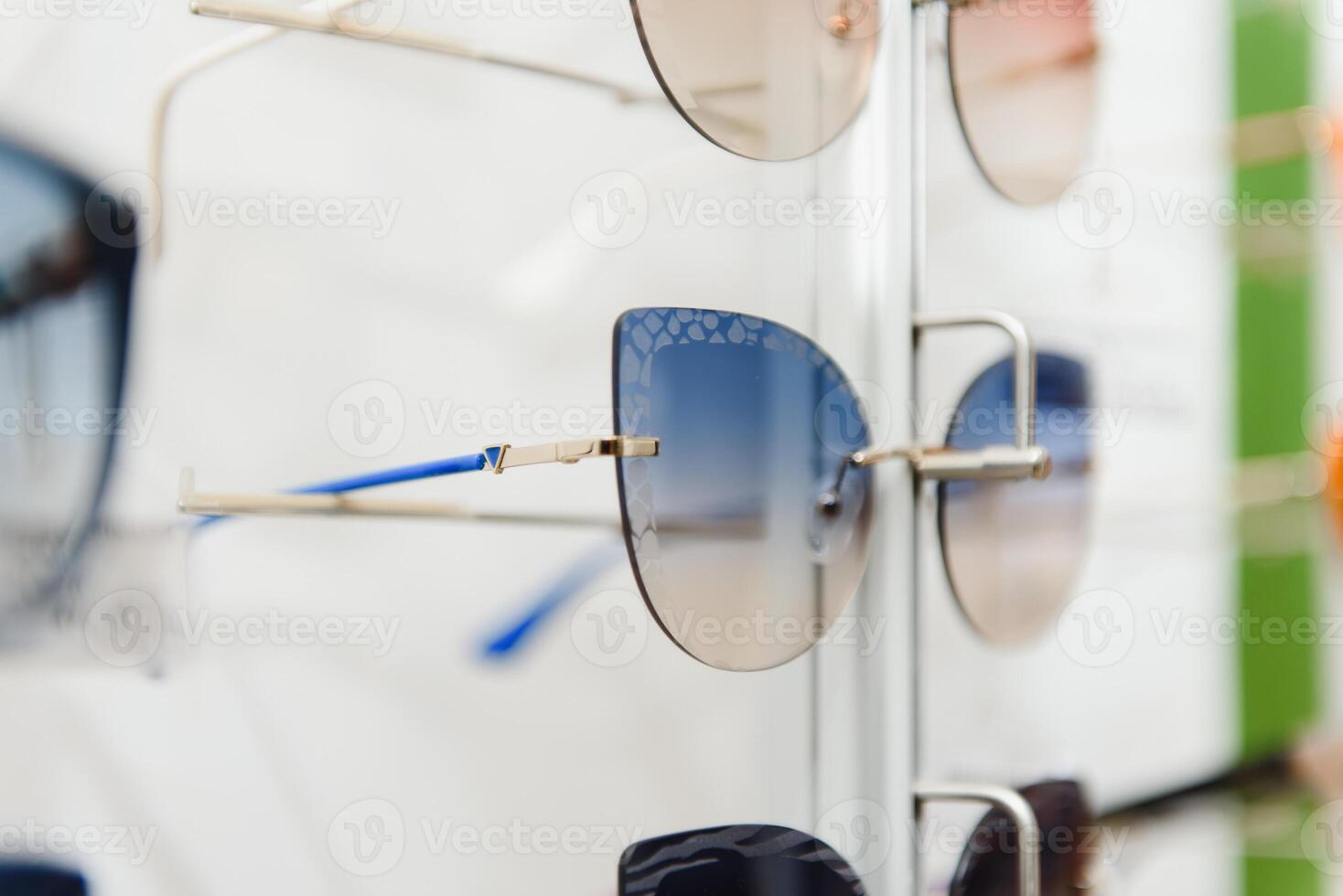 rack with glasses and sunglasses close up. photo