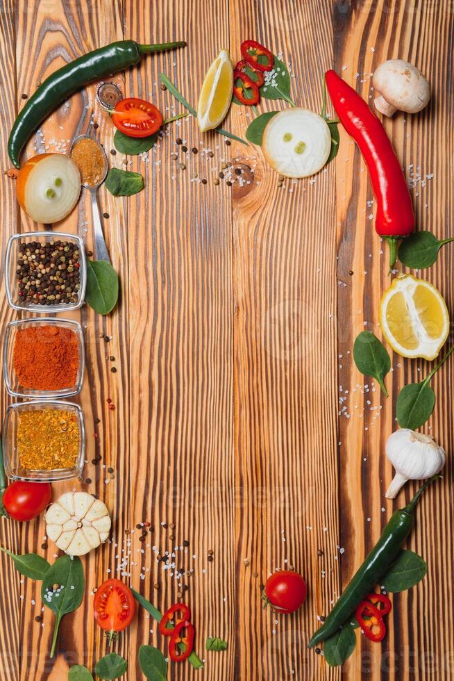 Cooking table. Background with spices and vegetables. Top view. Free space for your text. photo