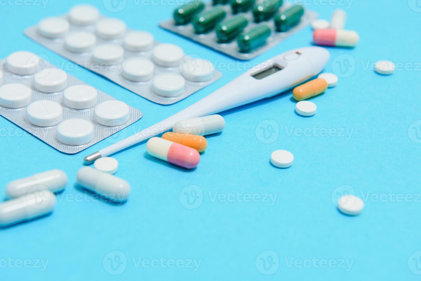 Supplements and pills blister packs, close-up. Place to insert your text, blue background. Pharmacists and clinics photo